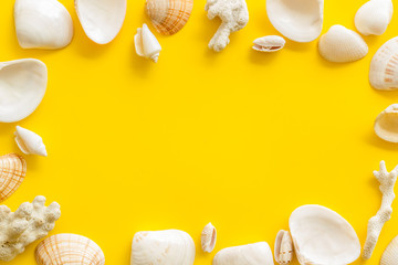 Seaside pattern with shells frame on yellow background top view mock up