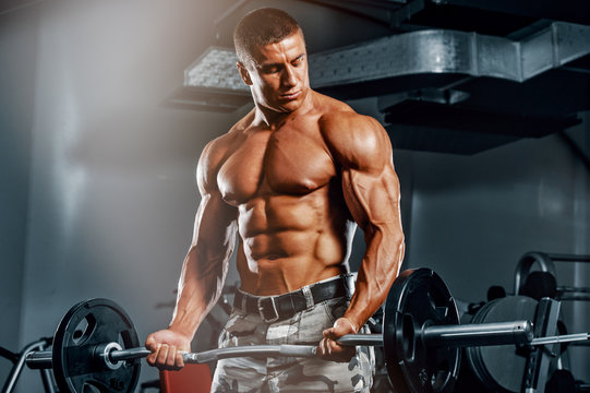 Bodybuilder Exercise With Weights at the Gym, Performing Bicep Curls