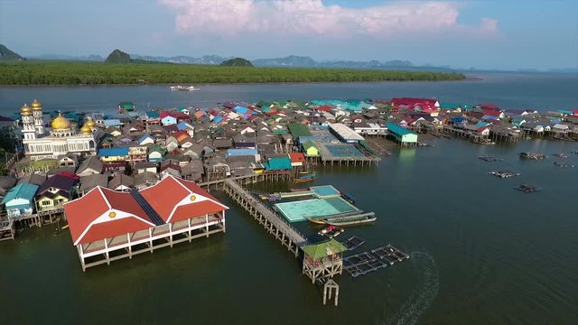 A high angled shot of a settlement at the base of a mountain surrounded by water in Thailand 