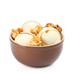 Delicious ice cream with caramel popcorn and sauce in bowl on white background