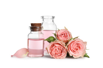 Obraz na płótnie Canvas Bottles of rose essential oil and flowers isolated on white
