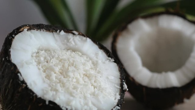 Coconut chips pouring into the coconut half