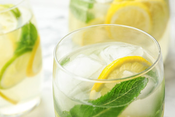 Glass of refreshing lemonade on table, closeup. Summer drink