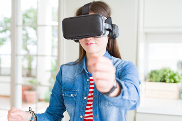 Young asian woman wearing virtual reality glasses smiling and concentrated playing video games of driving a car