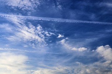 Detailed view on aircraft contrails in a deep blue sky