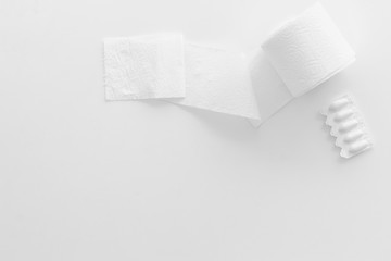 Toilet paper roll and rectal suppository for proctology diseases concept on white background top view mock up