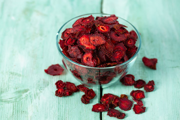 dried sliced strawberry on a wooden surface