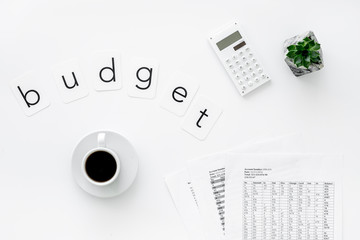 Business and accountant concept with coffee, budget copy and calculator on white office background top view