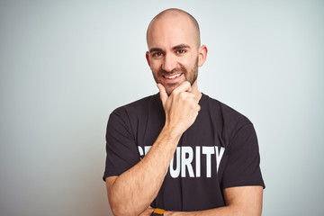 Young safeguard man wearing security uniform over isolated background looking confident at the...
