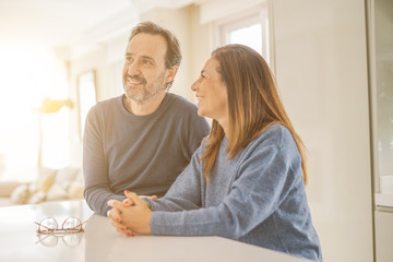 Romantic middle age couple sitting together at home
