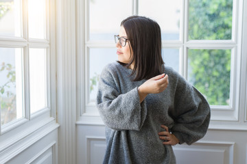 Young beautiful woman wearing glasses smiling cheerful standing casual at home on a sunny day