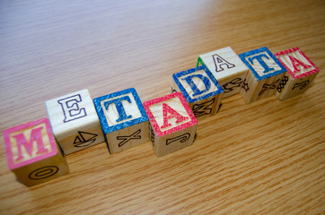 Educational toy cubes with letters organised to display word metadata - keywording and Search engine optimisation concept