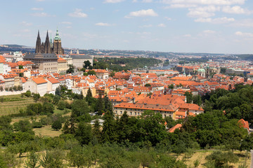Summer Prague City with gothic Castle and the green Nature  from the Hill Petrin, Czech Republic