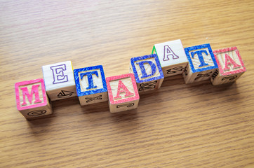 Educational toy cubes with letters organised to display word metadata - keywording and Search engine optimisation concept