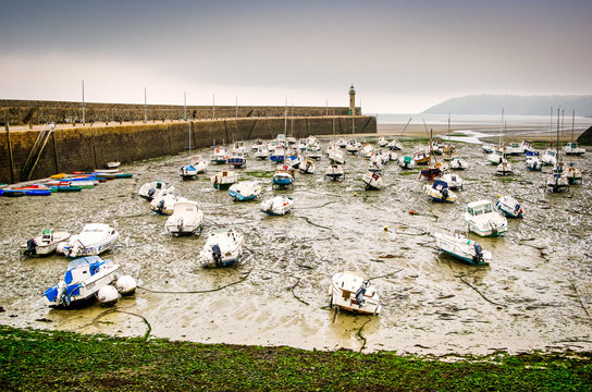Binic, France - June, 27, 2012. Port with boats on bottom without water at low tide