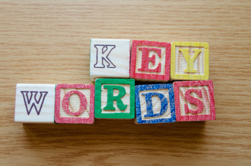 Educational toy cubes with letters organised to display word KEYWORDS - editing metadata and Search engine optimisation concept
