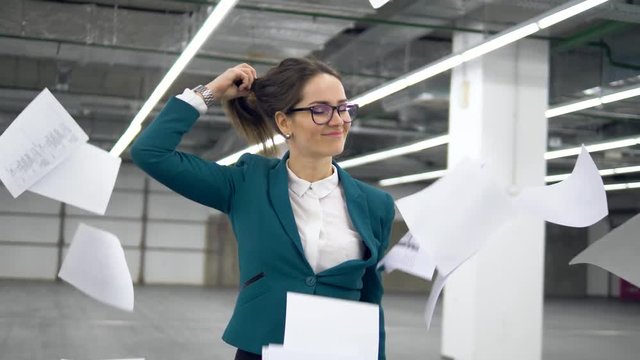 Young businesswoman is having fun in an empty hall