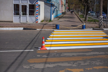 Marking a pedestrian crossing on a city street. Road painting for pedestrian orientation. Movement...