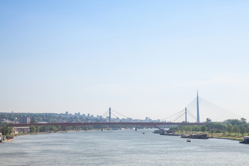 Panorama Belgrade brigdes over the Sava river (Ada, Gazela, the old and the new railway bridges) taken during a summer afternoon. Beograd is the capital city of Serbia