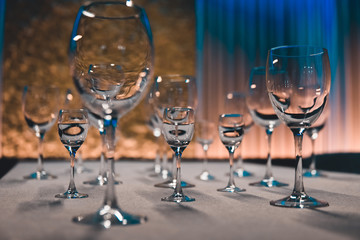 table setting with shiny wineglasses in restaurant