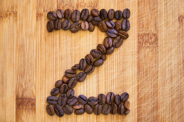 Alphabet letter Z made from roasted coffee beans, 3D rendering on wooden table background