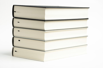 A set of five neatly stacked and arranged monochromatic cloth-bound books on a plain white background.