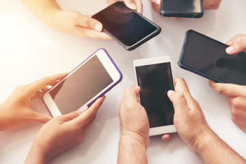 Group of hands people using and looking at mobile phone