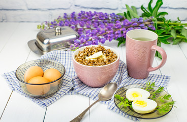 delicious buckwheat porridge with butter and boiled chicken egg, delicious and nutritious Breakfast, food close-up