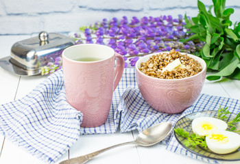 delicious buckwheat porridge with butter and boiled chicken egg, delicious and nutritious Breakfast, food close-up