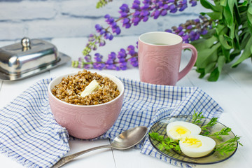 delicious buckwheat porridge with butter and boiled chicken egg, delicious and nutritious Breakfast, food close-up