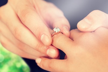 Close up Groom Putting the Wedding Ring on bride