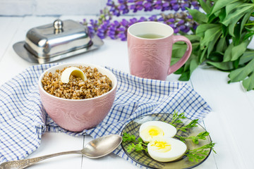 delicious buckwheat porridge with butter and boiled chicken egg, delicious and nutritious Breakfast, food close-up