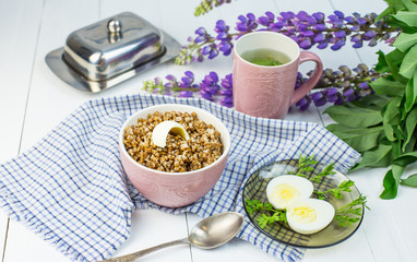 delicious buckwheat porridge with butter and boiled chicken egg, delicious and nutritious Breakfast, food close-up