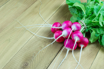 bunch of juicy radishes on wooden background