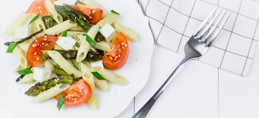 Penne pasta with tomatoes and asparagus.