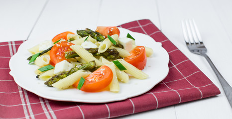 Penne pasta with tomatoes and asparagus.