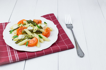 Penne pasta with tomatoes and asparagus.