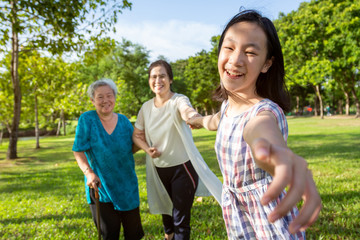 Happy asian family time together outdoor in nature,little child girl or granddaughter playing,fun,smile with mother and senior grandmother with walker in park,harmony in family life,love,care concept