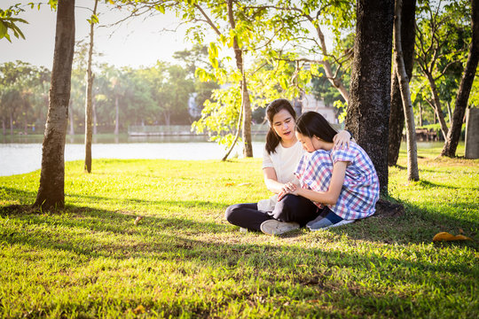 Asian Mother Give Advice,talking To Her Daughter To Encourage Her ,sad Child Girl Crying,discourage And Mom Comforting In Summer Outdoor Park,care,love,family Life And Consultation Concept