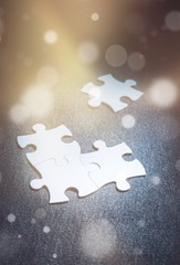 Fitting last white puzzle piece. Concept image of building and button up.