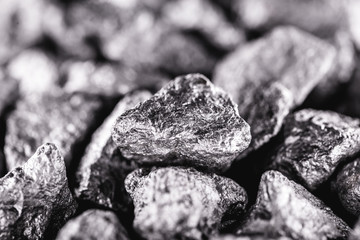 Manganese in the raw state. Manganese stone isolated on black background. Mineral extraction of...