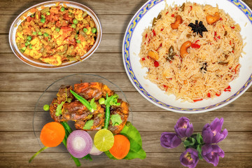 Delicious Indian meal of prawn fried rice with mixed vegetables along with red hot spicy lobster dish garnished with salad 