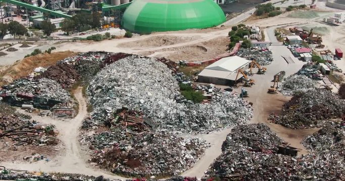 drone view of tons of industrial waste on the gorund near the fuel power station. aerial footage of the large station with green blocks in larnaca, cyprus.