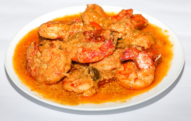 Indian spicy food shrimp curry prepared with coconut served as side dish with rice isolated on white background