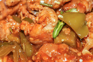 Chilli chicken - Spicy Indian food prepared with chicken in gravy sauce served with green chilli in macro view