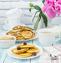 Delicious Breakfast, pancakes with sour cream, honey and cherries.