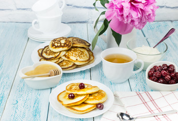 Delicious Breakfast, pancakes with sour cream, honey and cherries.