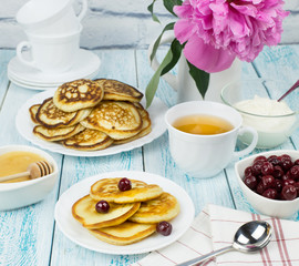 Delicious Breakfast, pancakes with sour cream, honey and cherries.