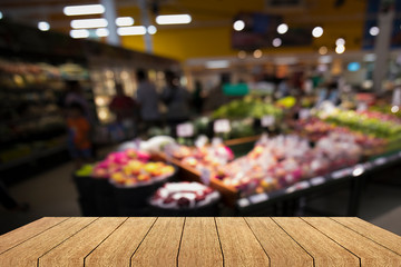 Wood floor and Supermarket blur background.Fruit vegetable shelf products