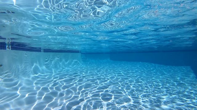 Slow motion view of underwater sunlight patterns in clean empty swimming pool.  Shot at 240 frames per second.  